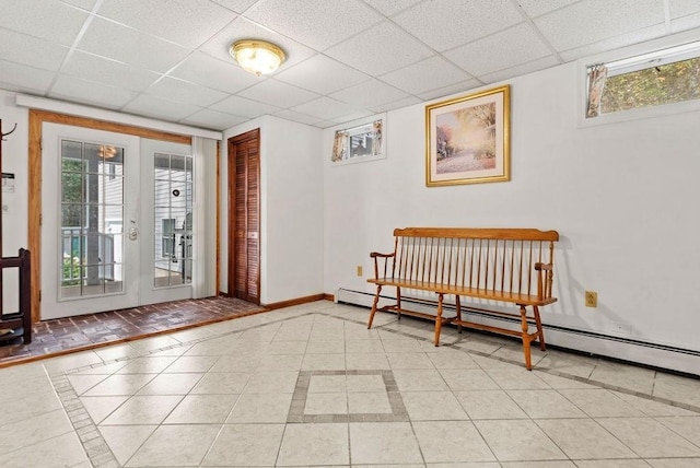 525 Thurston St, Wrentham, MA 02093 - foyer entrance with a drop ceiling, inlaid floor details, baseboards, and a baseboard radiator