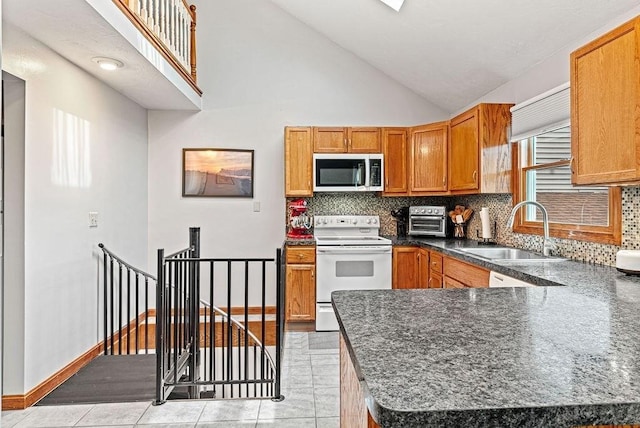 525 Thurston St, Wrentham, MA 02093 - kitchen featuring stainless steel microwave, electric range, a sink, tasteful backsplash, and high vaulted ceiling