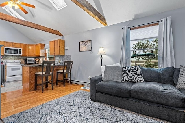 525 Thurston St, Wrentham, MA 02093 - living room featuring healthy amount of natural light, light wood-type flooring, a ceiling fan, and a skylight