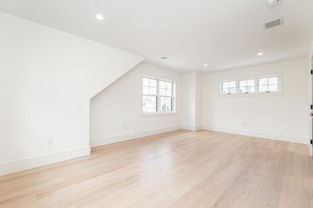 interior space featuring recessed lighting, visible vents, light wood-style flooring, and baseboards