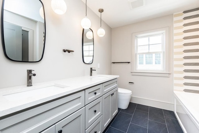 full bathroom with toilet, tile patterned flooring, double vanity, and a sink