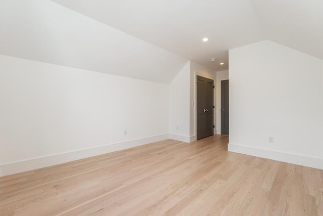 bonus room with vaulted ceiling, recessed lighting, light wood-style flooring, and baseboards