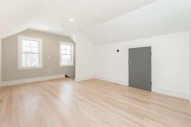 bonus room with lofted ceiling, baseboards, light wood finished floors, and recessed lighting