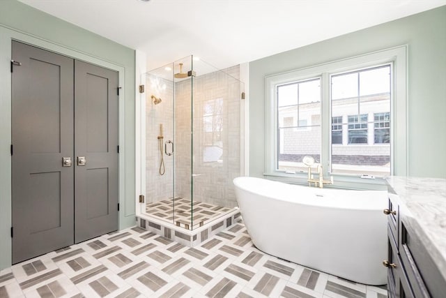 bathroom featuring tile patterned flooring, a soaking tub, and a shower stall