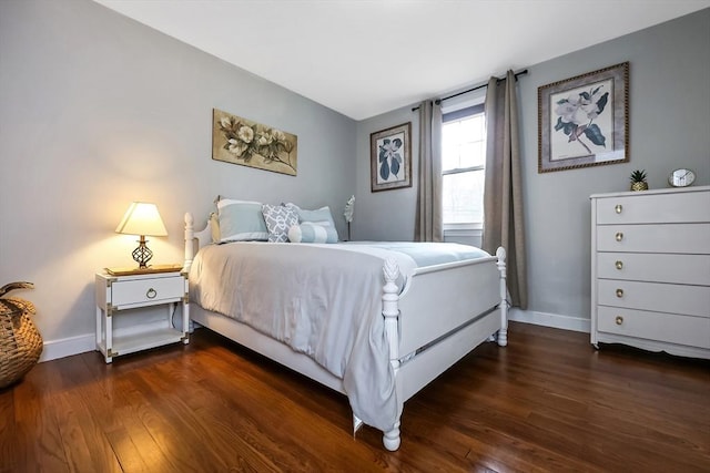 bedroom featuring dark wood-style floors and baseboards