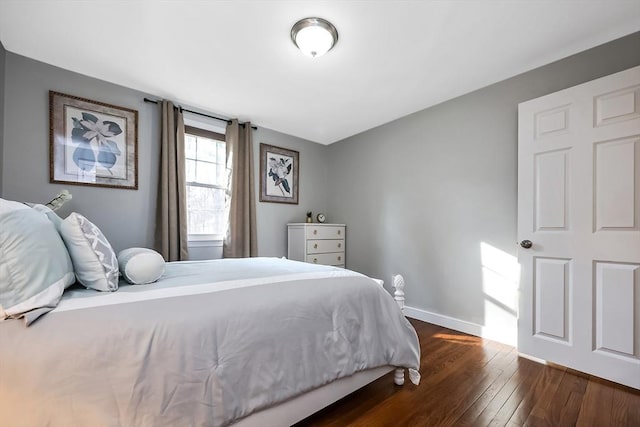 bedroom with baseboards and dark wood finished floors