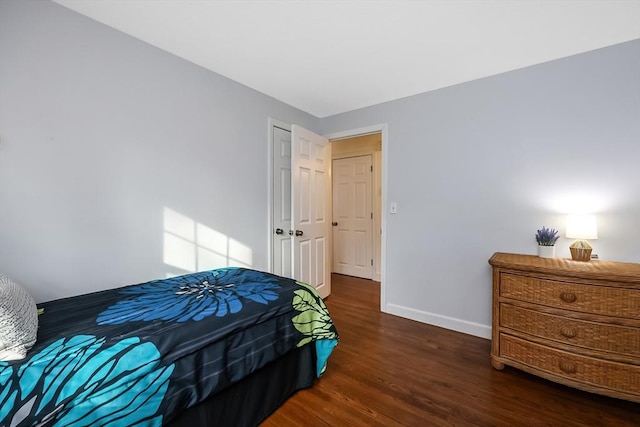 bedroom with baseboards and wood finished floors