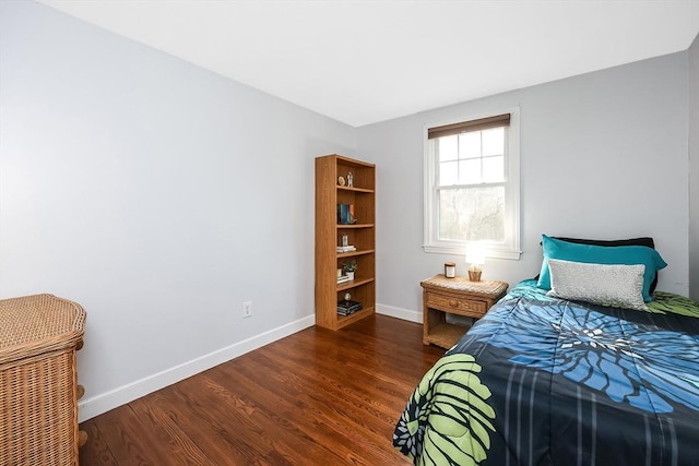 bedroom with dark wood-style flooring and baseboards