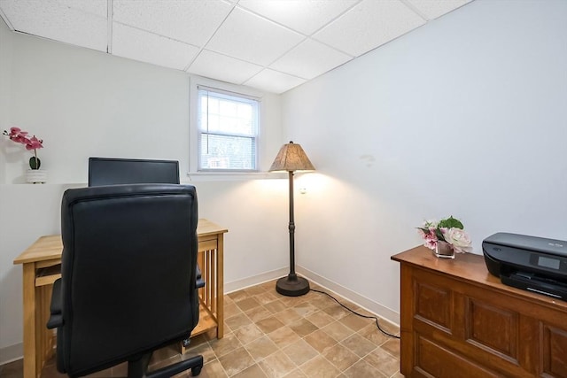 office featuring baseboards and a drop ceiling