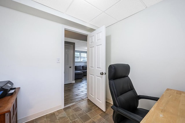 office with a drop ceiling and baseboards