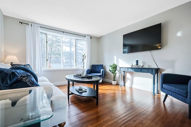 living room with wood-type flooring and baseboards