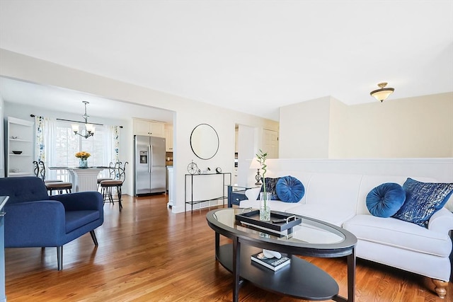 living room featuring light wood-style floors and a chandelier