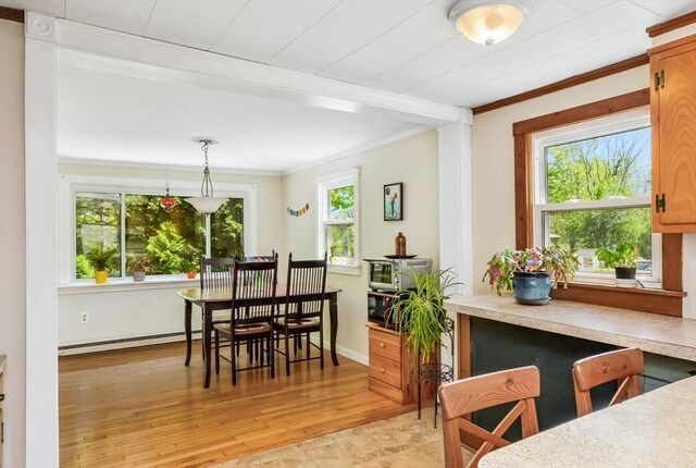 130 N Walker St, Taunton, MA 02780 - dining area featuring ornamental molding, a baseboard heating unit, light wood-style flooring, and baseboards