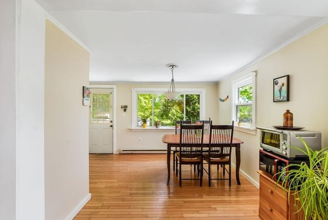 130 N Walker St, Taunton, MA 02780 - dining space with crown molding, light wood-style flooring, baseboards, and a baseboard radiator