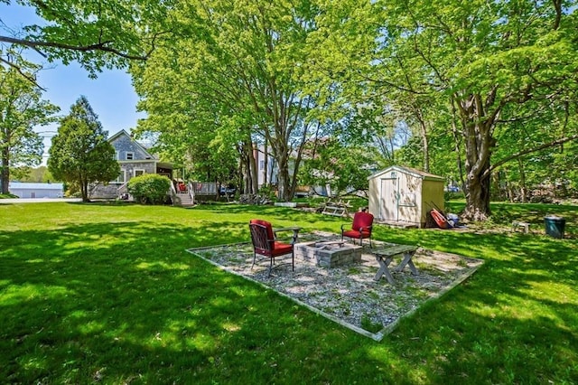 130 N Walker St, Taunton, MA 02780 - view of grassy yard with an outdoor fire pit, a storage shed, and an outdoor structure