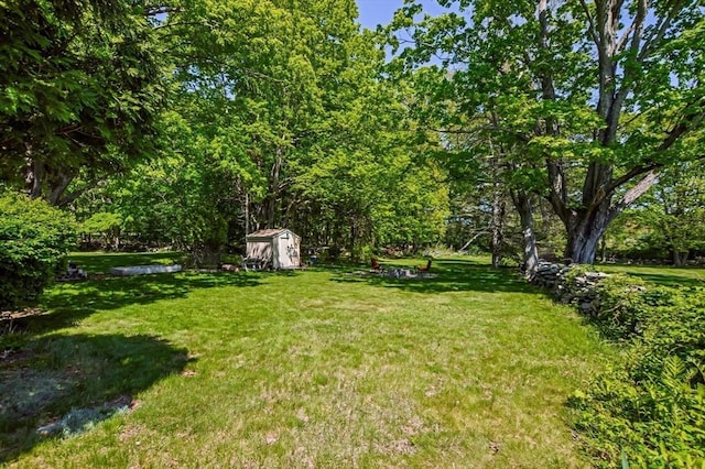 130 N Walker St, Taunton, MA 02780 - view of grassy yard featuring a storage unit and an outbuilding