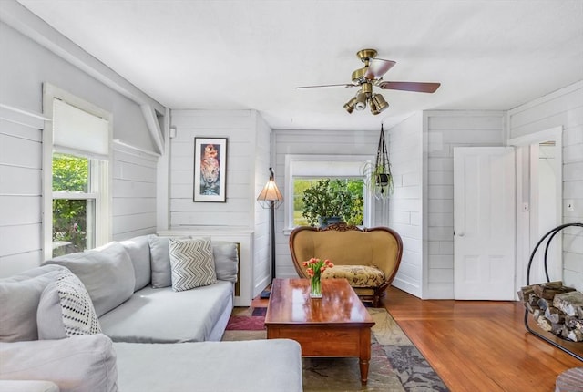 130 N Walker St, Taunton, MA 02780 - living area featuring a ceiling fan, wood finished floors, and wooden walls