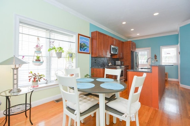 41 Oak St Unit 2, Waltham, MA 02453 - dining room with light wood-type flooring, crown molding, and recessed lighting