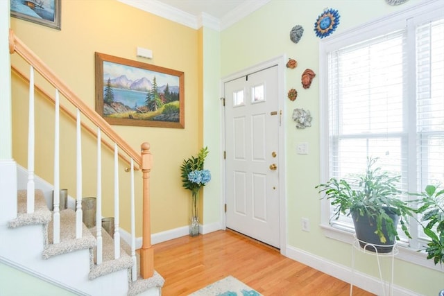 41 Oak St Unit 2, Waltham, MA 02453 - foyer entrance with light wood-type flooring, stairs, and crown molding