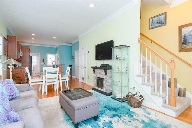 41 Oak St Unit 2, Waltham, MA 02453 - living area with ornamental molding, wood finished floors, stairway, recessed lighting, and a stone fireplace