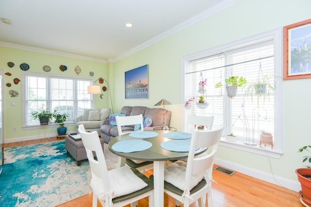 41 Oak St Unit 2, Waltham, MA 02453 - dining space featuring ornamental molding and wood finished floors