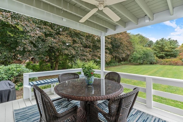 wooden deck with ceiling fan, a yard, and outdoor dining space