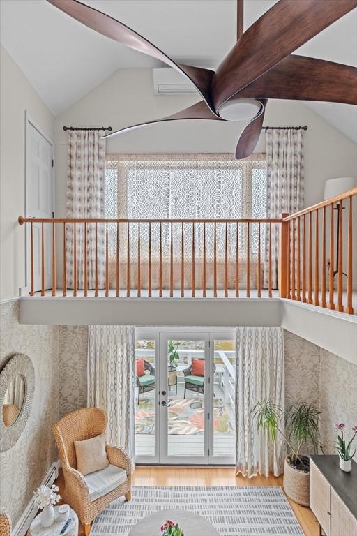 sitting room with wood finished floors and lofted ceiling