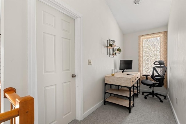 carpeted home office with baseboards and vaulted ceiling