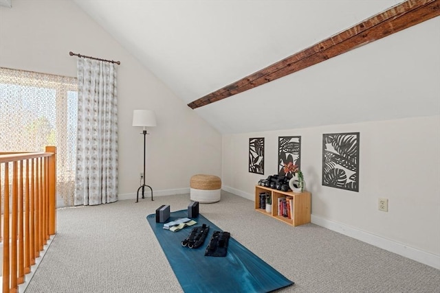 exercise room featuring carpet floors, baseboards, and vaulted ceiling