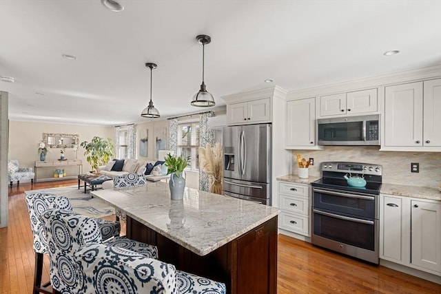 kitchen featuring white cabinetry, appliances with stainless steel finishes, and light stone countertops