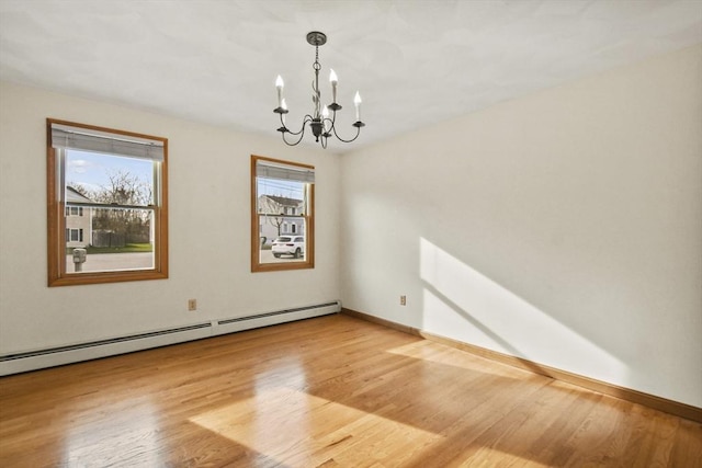 unfurnished room with a chandelier, hardwood / wood-style flooring, and a baseboard radiator