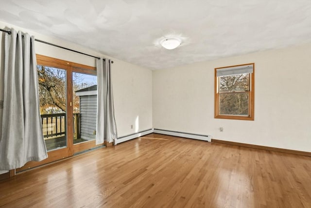 empty room with light hardwood / wood-style flooring and a baseboard heating unit