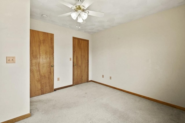 spare room featuring ceiling fan and light colored carpet