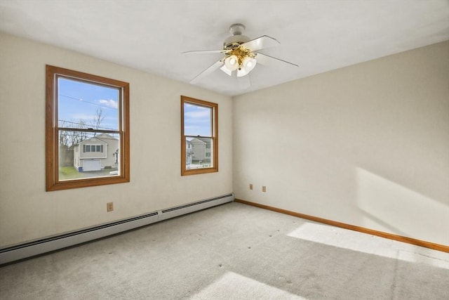 empty room with baseboard heating, light carpet, ceiling fan, and a healthy amount of sunlight