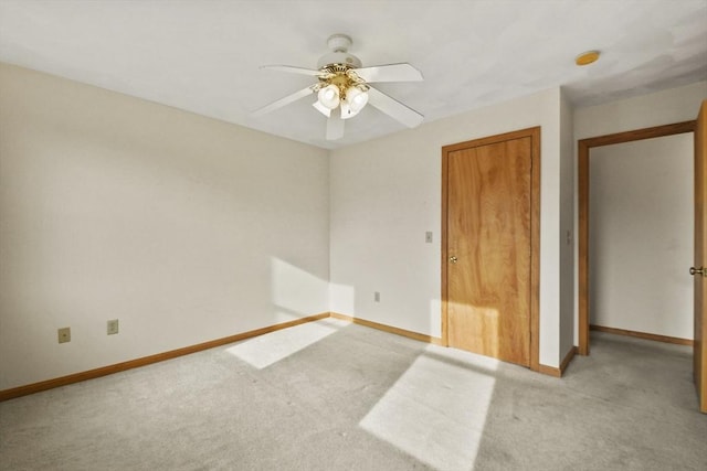 unfurnished bedroom featuring ceiling fan, light colored carpet, and a closet