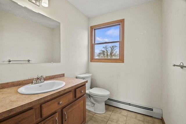 bathroom with tile patterned flooring, vanity, a baseboard radiator, and toilet