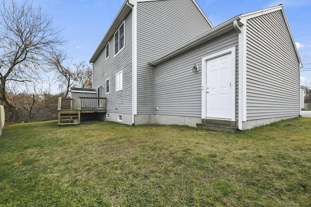 rear view of property featuring a wooden deck and a yard