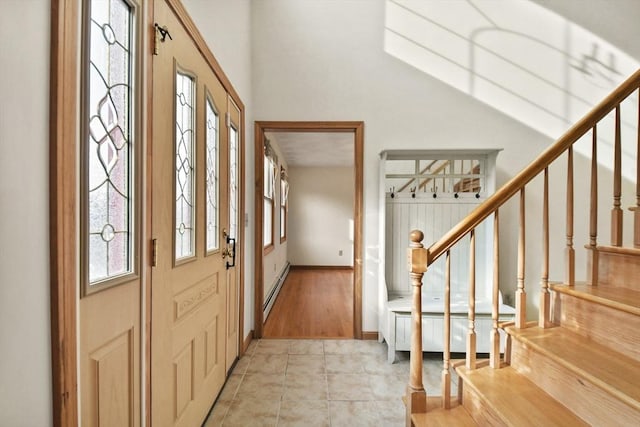 entrance foyer featuring baseboard heating and light hardwood / wood-style flooring