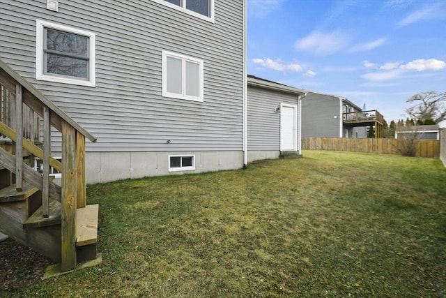 view of side of home with a yard