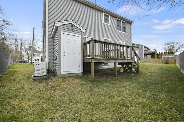 back of house with a yard and a deck