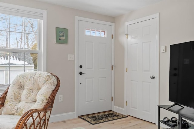 entryway featuring baseboards and light wood-type flooring