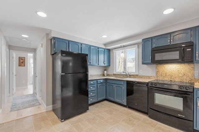 kitchen with black appliances, blue cabinets, backsplash, and a sink