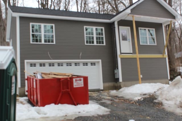 view of front of house featuring a garage and washer / clothes dryer