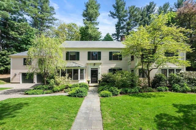 40 Channing Rd, Dedham, MA 02026 - colonial inspired home featuring a front yard, a chimney, driveway, and a garage
