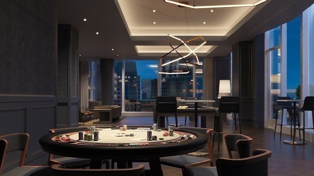 dining space with a tray ceiling and a chandelier