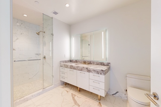 bathroom featuring vanity, toilet, and a shower with shower door