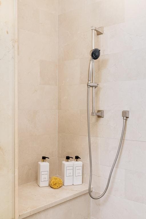 bathroom with a tile shower