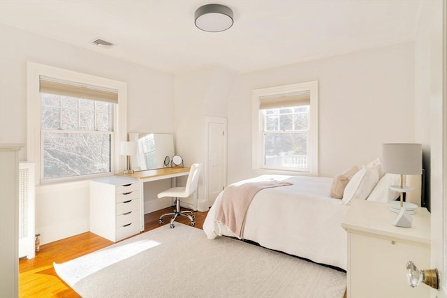 bedroom with light hardwood / wood-style floors