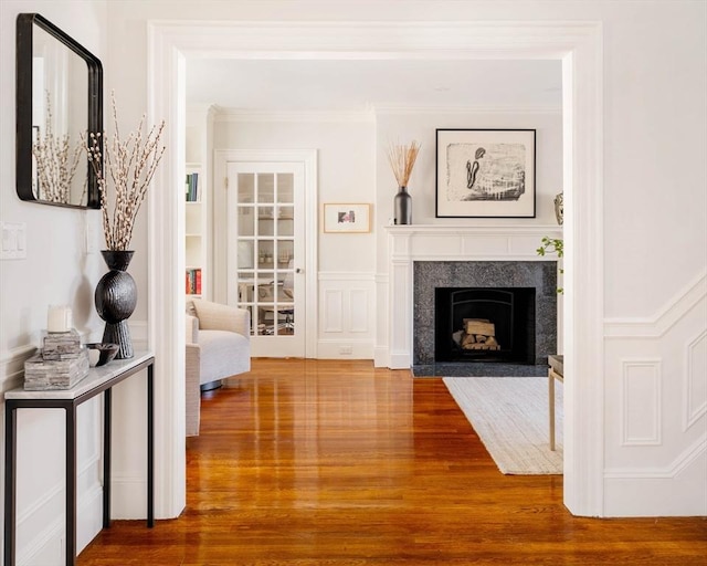 interior space with hardwood / wood-style floors and ornamental molding