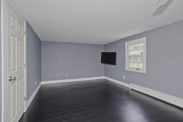 7 Summit Dr, Westfield, MA 01085 - empty room featuring a baseboard radiator, dark wood-type flooring, and a textured ceiling